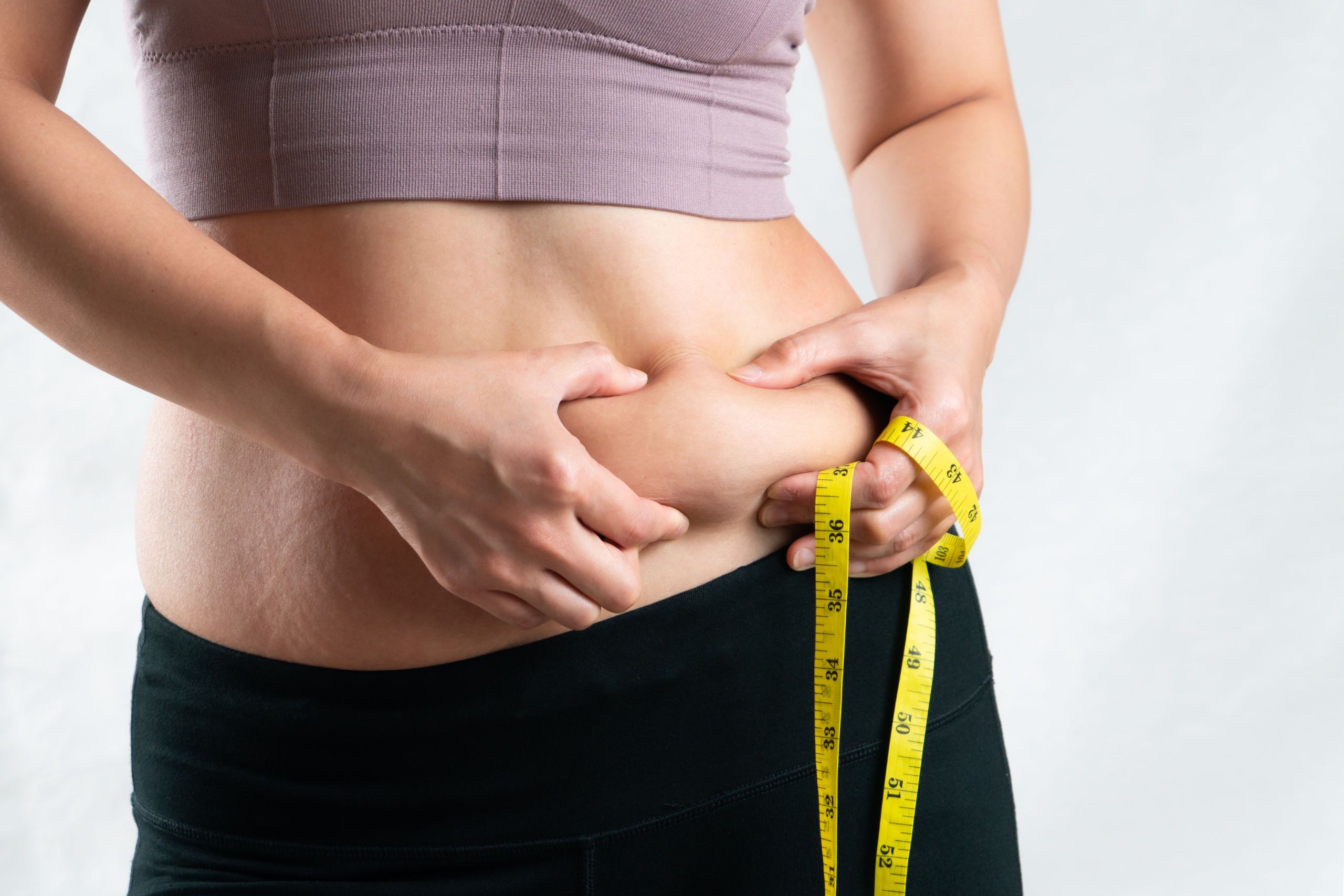 lady holding her belly fat