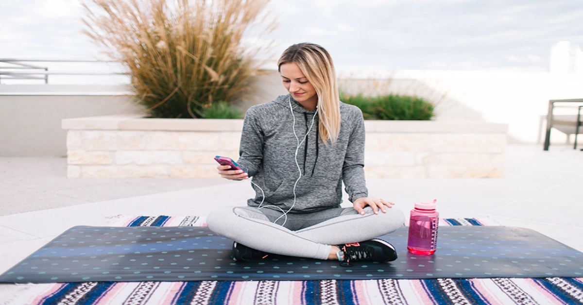 a picture of woman sitting on a mat
