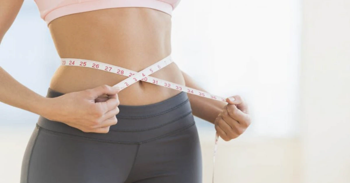 woman with a measuring tape around her waiste