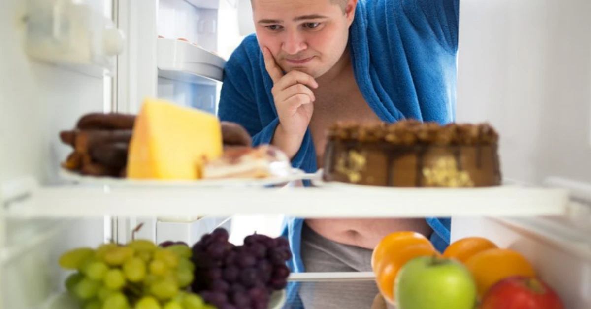 man looking inside a fridge